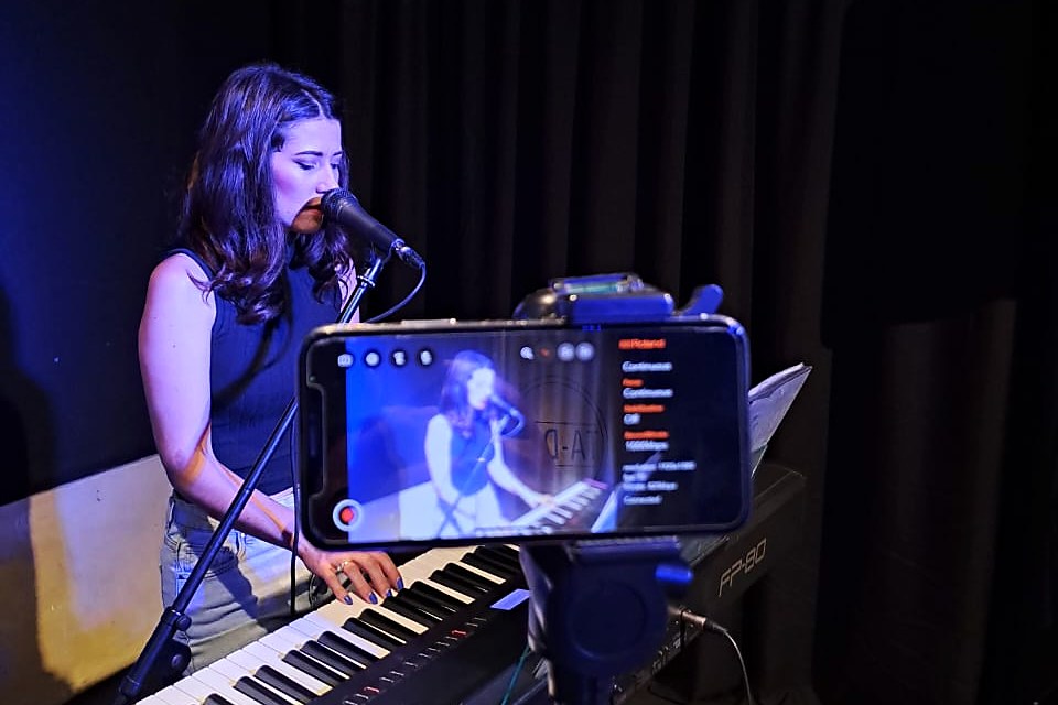 Danielle singing and leading worship from the keys