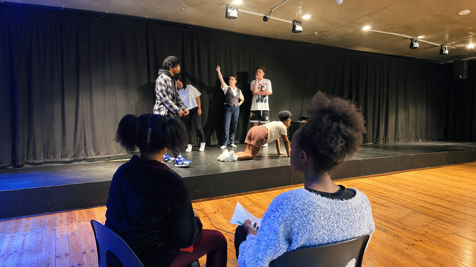 Students rehearsing a scene on stage in a TA-DA! acting class