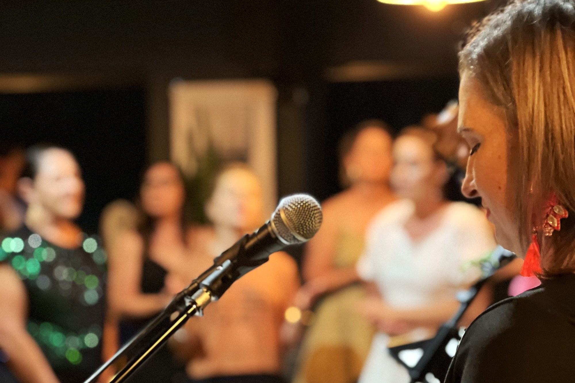 Worship leader at the keys with singers behind