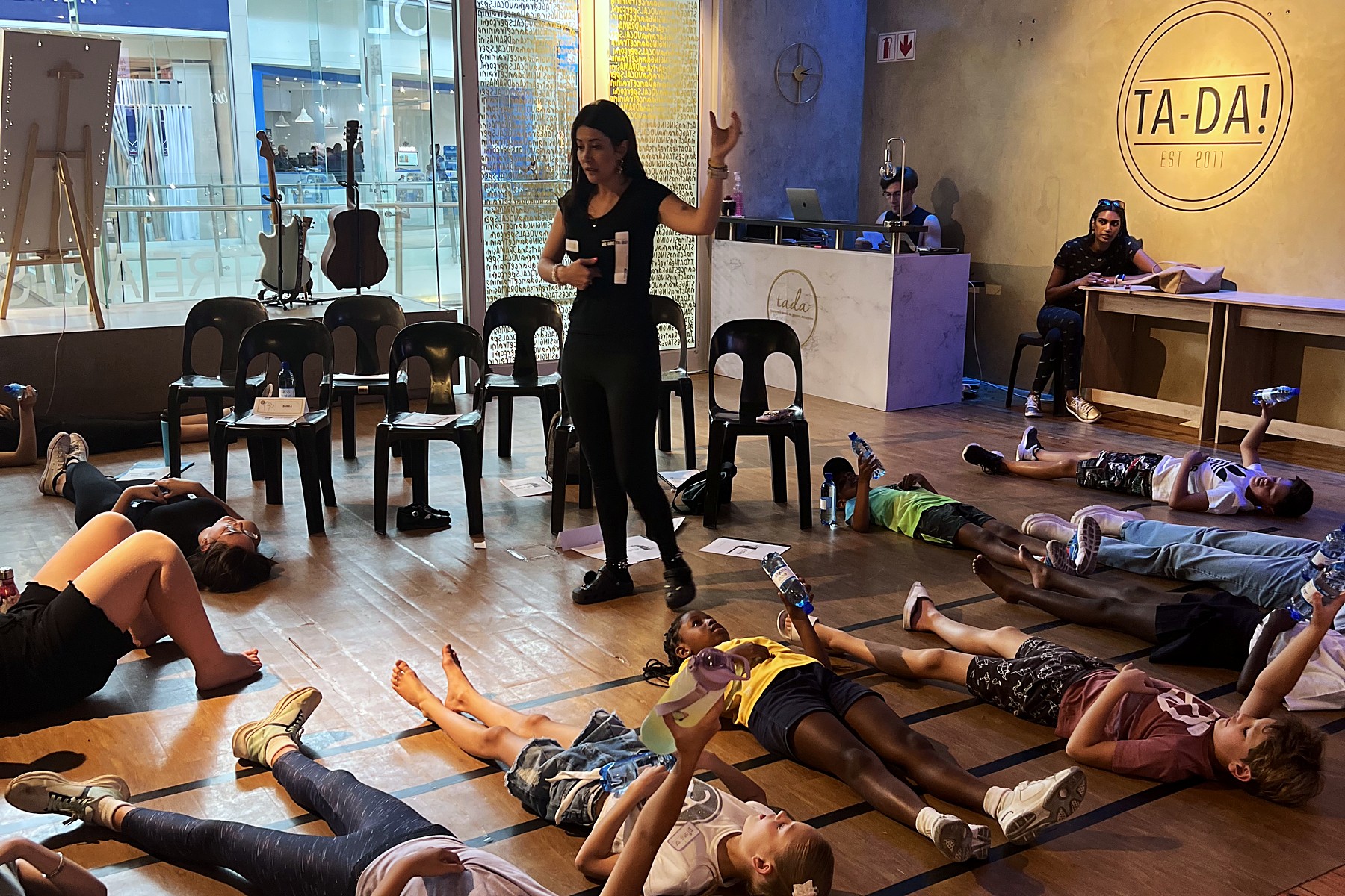 Students doing a voice and breathing exercise in the TA-DA! studio