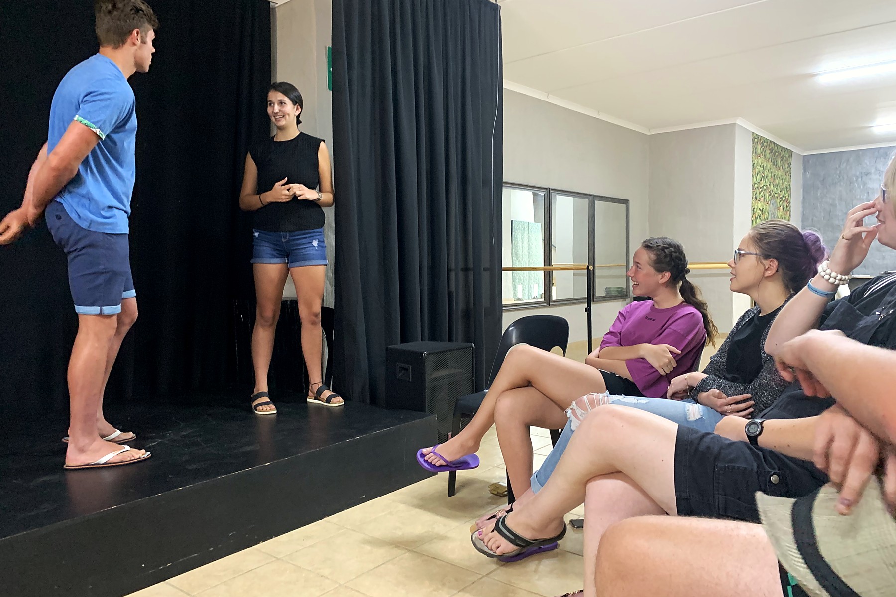 Two students performing a scene while their class watches